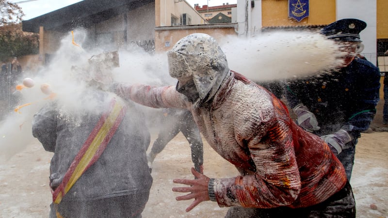 Revellers battle with flour and eggs during the Els Enfarinats festival in Spain