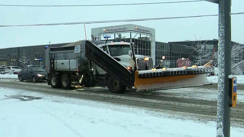A snow plow clears the roadway in Toronto on Dec. 10, 2025.