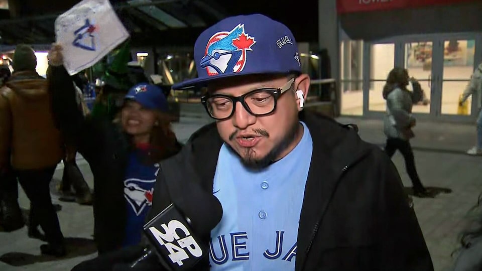 'Supporting the team, feeling the vibe': Fans cheer on the Jays from outside Rogers Centre